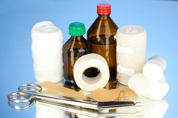 First aid kit for bandaging on blue background
