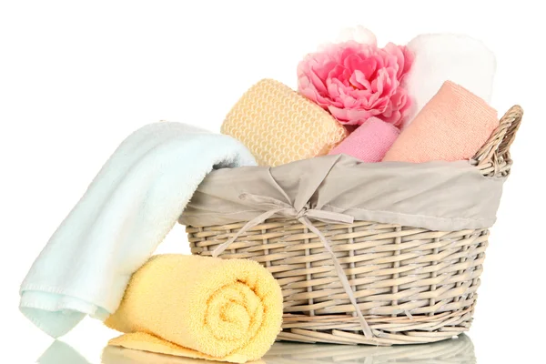 Bathroom towels folded in wicker basket isolated on white — Stock Photo, Image