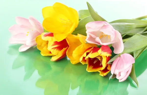 Beautiful tulips in bucket on green background — Stock Photo, Image