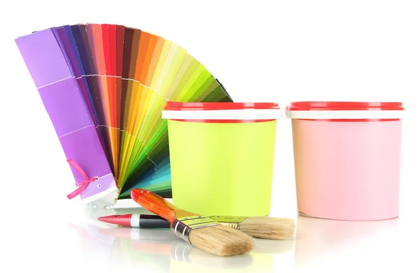 Paint pots, paintbrushes and coloured swatches isolated on white — Stock Photo, Image