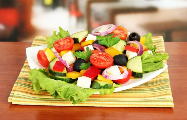 Tasty Greek salad on table in cafe — Stock Photo, Image