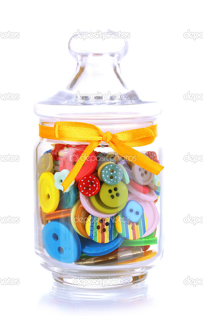 Glass jar containing various colored buttons isolated on white