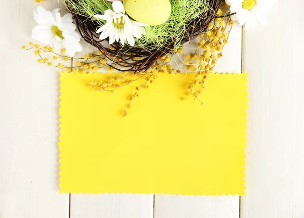 Empty card with easter eggs and mimosa flowers, on white wooden background — Stock Photo, Image