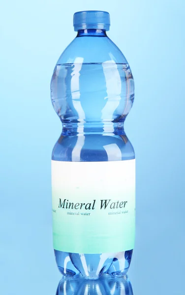 Water bottle with label on blue background — Stock Photo, Image