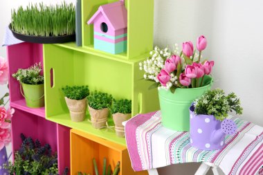 renkli raf ve dekoratif öğeler ve çiçekler ile tablo