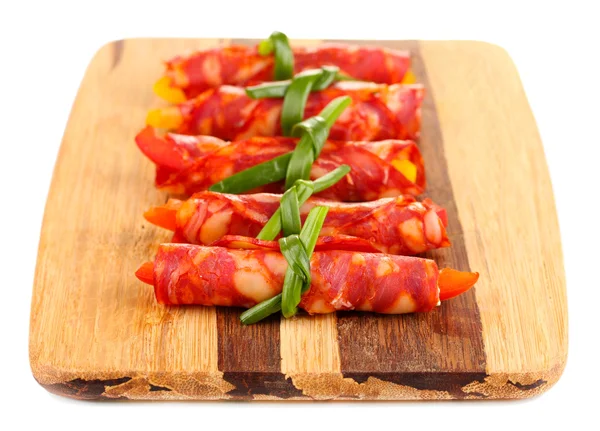 Salami rolls on wooden board, isolated on white — Stock Photo, Image
