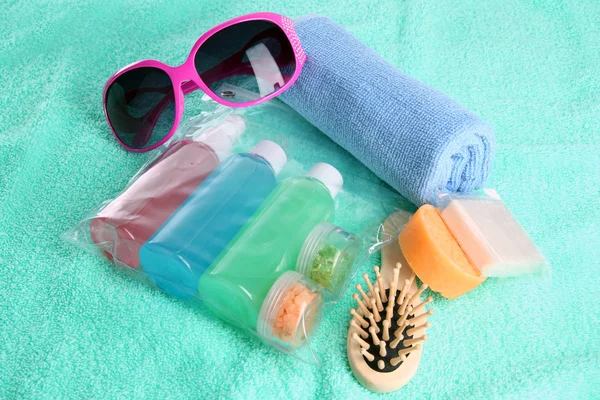 Hotel cosmetics kit on blue towel — Stock Photo, Image