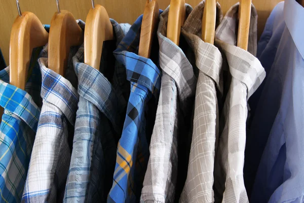 Men's shirts on hangers in wardrobe — Stock Photo, Image