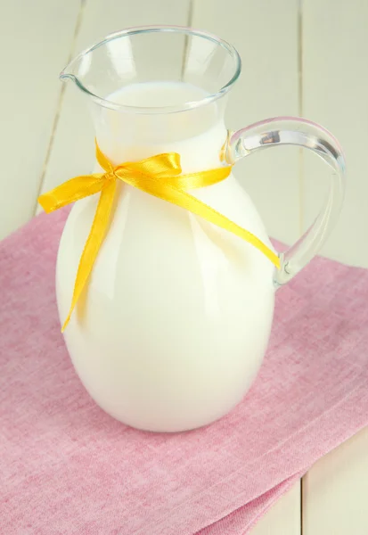 Pitcher of milk on table in room — Stock Photo, Image