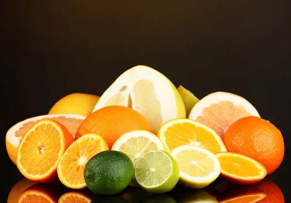 Lots ripe citrus on dark color background — Stock Photo, Image