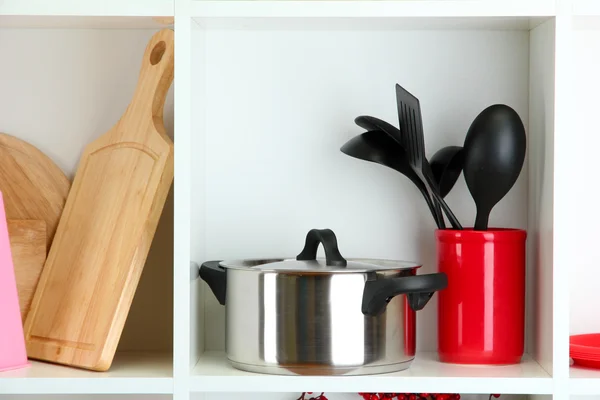 Beautiful white shelves with tableware and deco — Stock Photo, Image