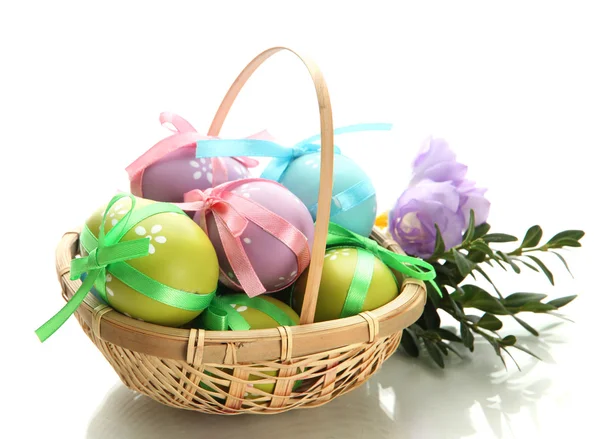 Sepette, üzerinde beyaz izole yay ile parlak Paskalya yumurtaları — Stok fotoğraf