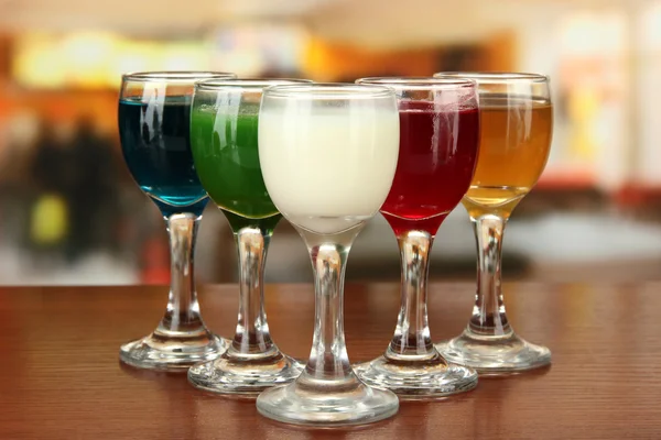 Tasty color liquors, on bright background — Stock Photo, Image