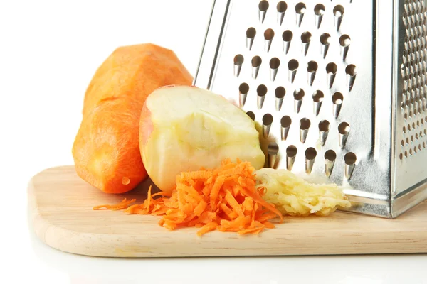 Metal grater and apple, carrot on cutting board, isolated on white — Stock Photo, Image