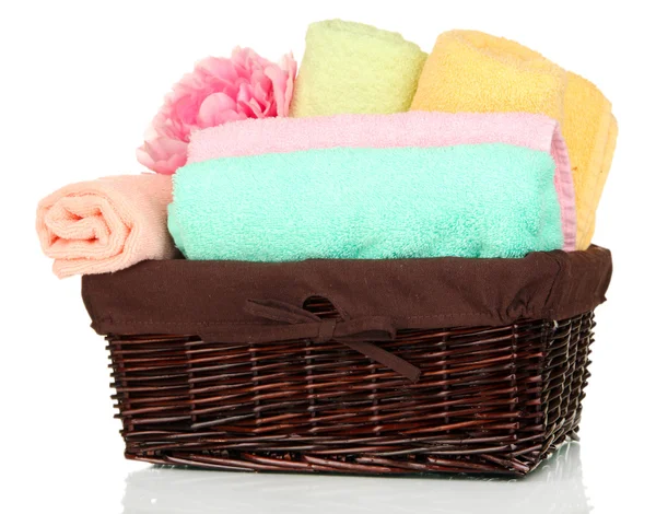 Bathroom towels folded in wicker basket isolated on white — Stock Photo, Image