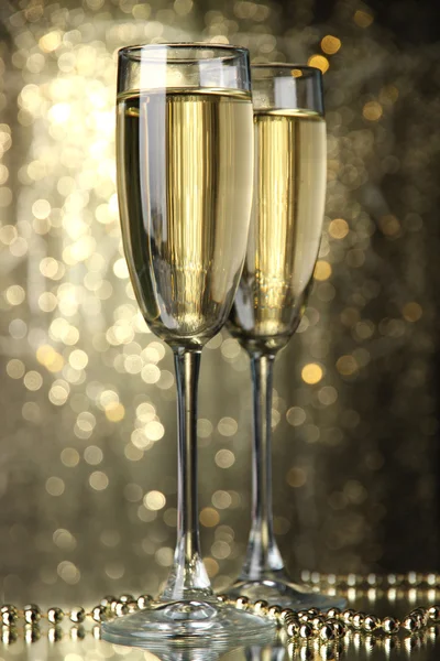 Two glasses of champagne on bright background with lights — Stock Photo, Image