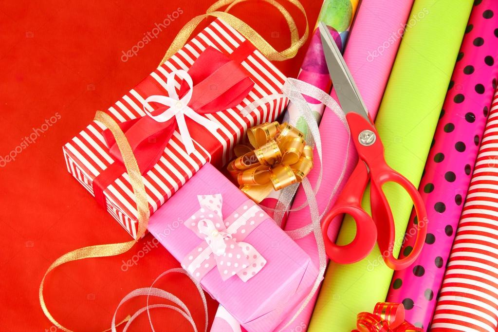 Rolls Of Christmas Wrapping Paper With Ribbons, Bows And Scissors