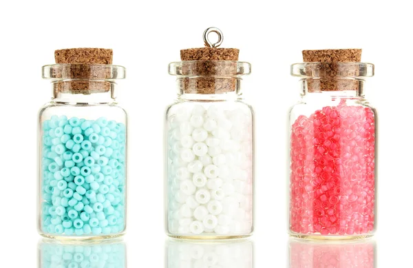 Little bottles full with colorful beads isolated on white — Stock Photo, Image