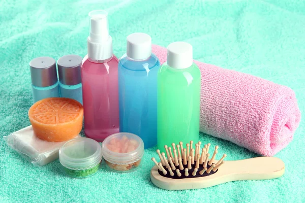 Hotel cosmetics kit on blue towel — Stock Photo, Image