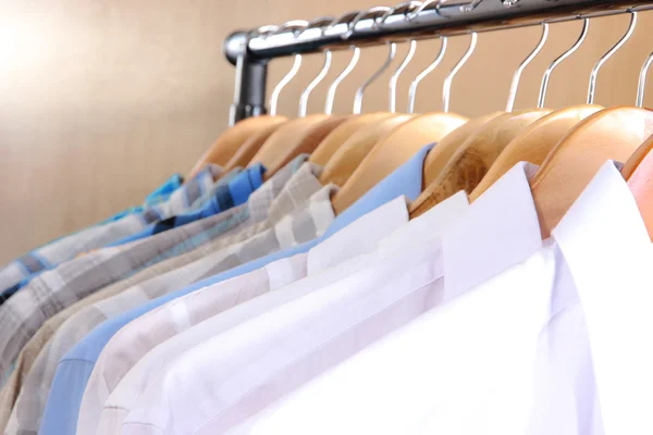 Men's shirts on hangers in wardrobe — Stock Photo, Image