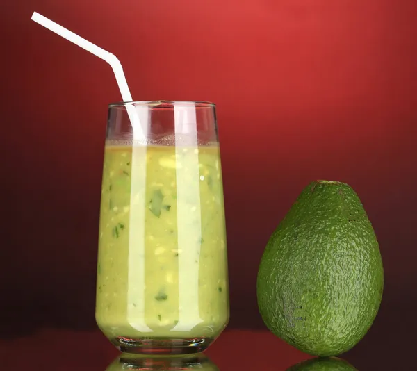 Nuttige verse avocado op donkere rode achtergrond — Stockfoto