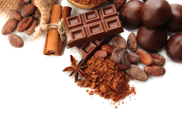 Composition of chocolate sweets, cocoa and spices, isolated on white — Stock Photo, Image