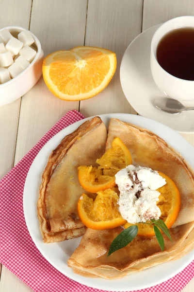 Pancakes with orange on wooden table — Stock Photo, Image