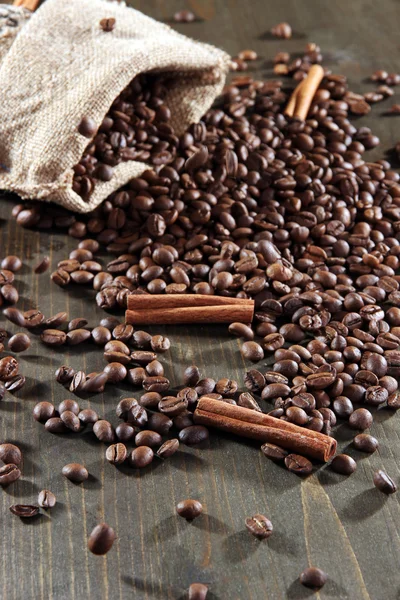 Coffee in sack on wooden table — Stock Photo, Image