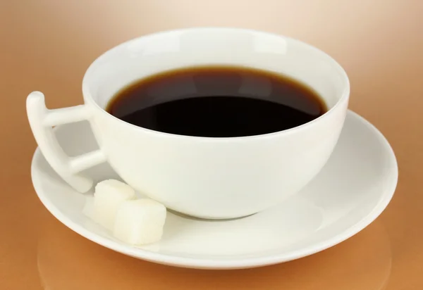 A cup of strong coffee on beige background — Stock Photo, Image