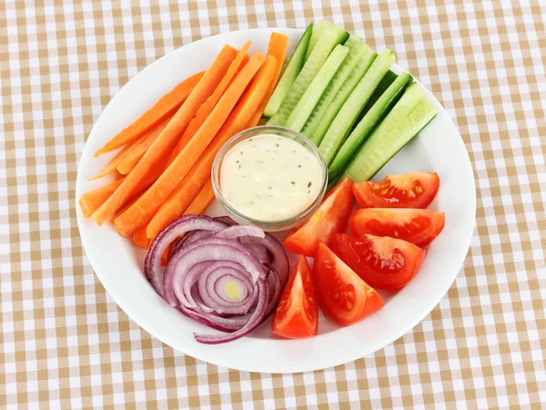 Diverse råa grönsaker pinnar i tallriken på bordet på nära håll — Stockfoto
