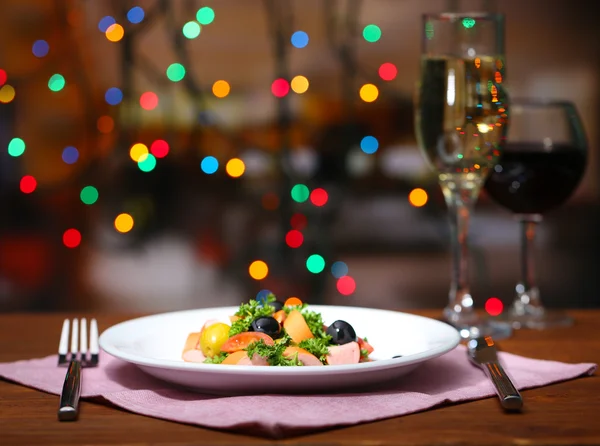 Tasty salad on dark background with bokeh defocused lights — Stock Photo, Image
