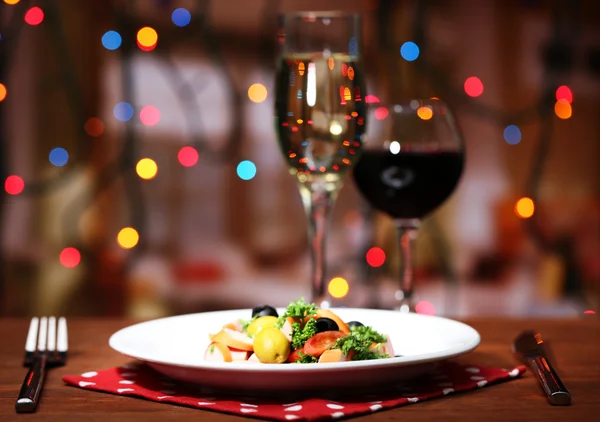 Tasty salad on dark background with bokeh defocused lights — Stock Photo, Image