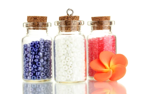 Little bottles full with colorful beads isolated on white — Stock Photo, Image