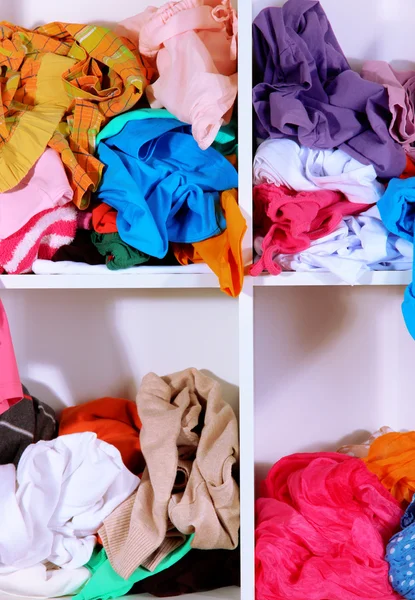 Clothing scattered on shelves — Stockfoto