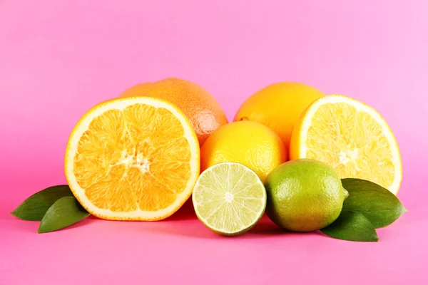 Fruits with leafs on pink background — Stock Photo, Image