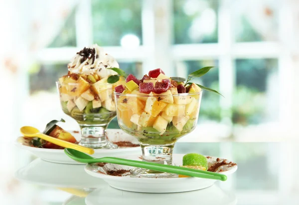 Fruit salad in a sundae dish on window background — Stock Photo, Image