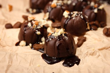 çikolata şekerleme ve bej renkli kağıt arka plan üzerinde kahve çekirdekleri