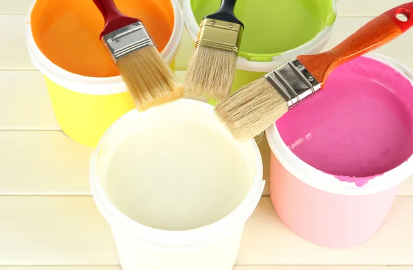 Set for painting: paint pots, brushes on white wooden table — Stock Photo, Image