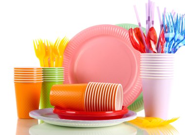 Multicolored plastic tableware isolated on white clipart