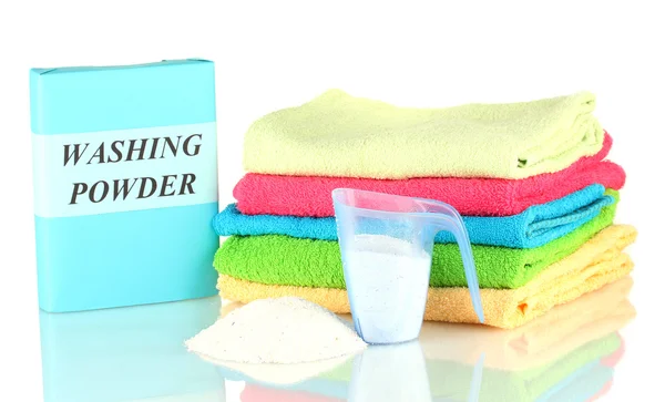 Box of washing powder with blue measuring cup and towels, isolated on white — Stock Photo, Image