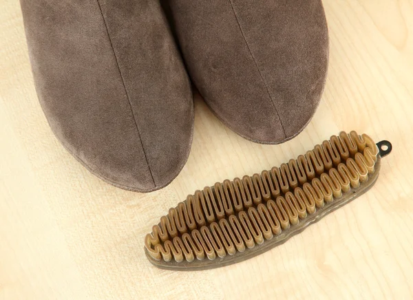 Brush for suede shoes, on wooden background — Stock Photo, Image