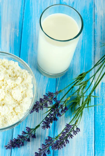 Glas Milch und Käse auf einem blauen Holztisch — Stockfoto