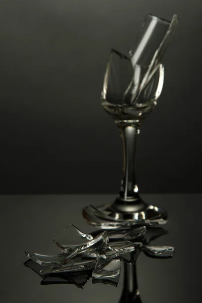 Broken wineglass on grey background — Stock Photo, Image