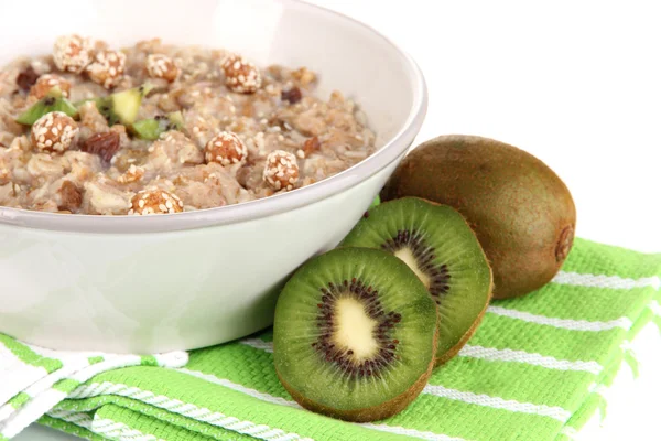 Harina de avena útil en tazón con fruta aislada en blanco — Foto de Stock