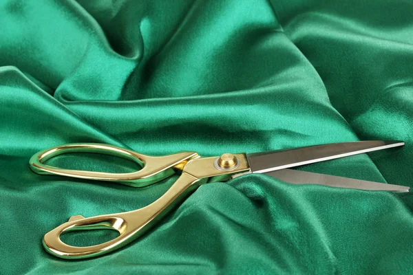 Metal scissors on green fabric — Stock Photo, Image