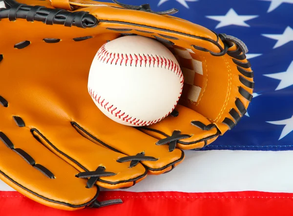 Guante de béisbol y pelota sobre fondo de bandera estadounidense — Foto de Stock