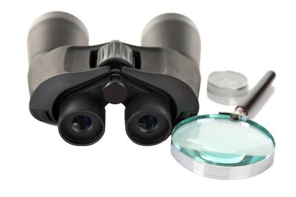 黑色现代双筒望远镜与放大镜和罗盘上白色隔离 — 图库照片