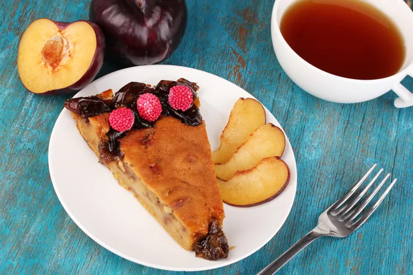 Tasty pie on plate on wooden table — Stock Photo, Image