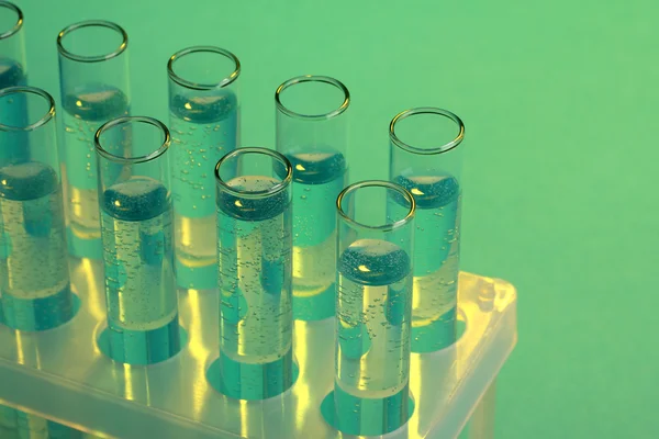 Test-tubes with liquid on blue background — Stock Photo, Image