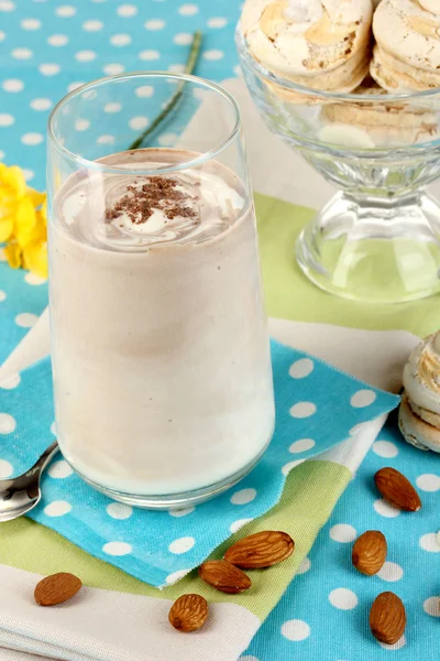 Glass of chocolate-cream cocktail on blue tablecloth close-up — Stock Photo, Image